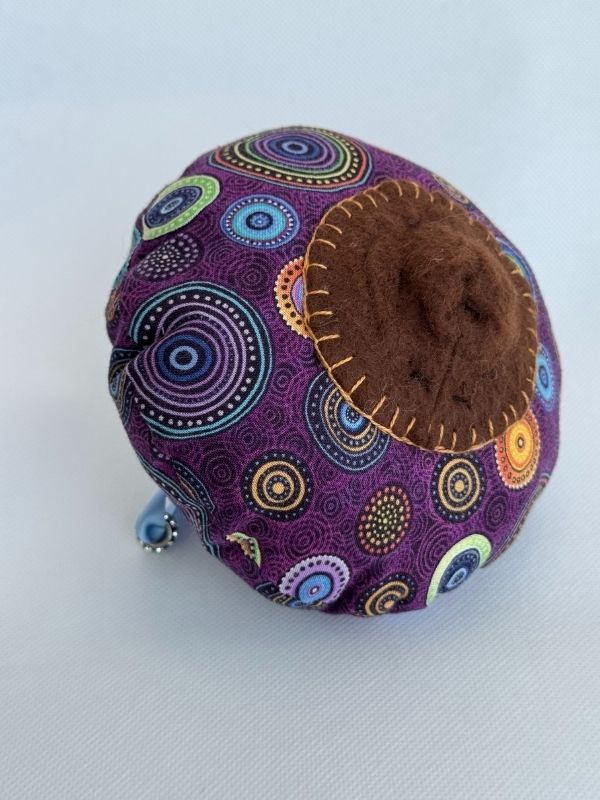 Purple cloth Aboriginal design pull cord breast mode side view